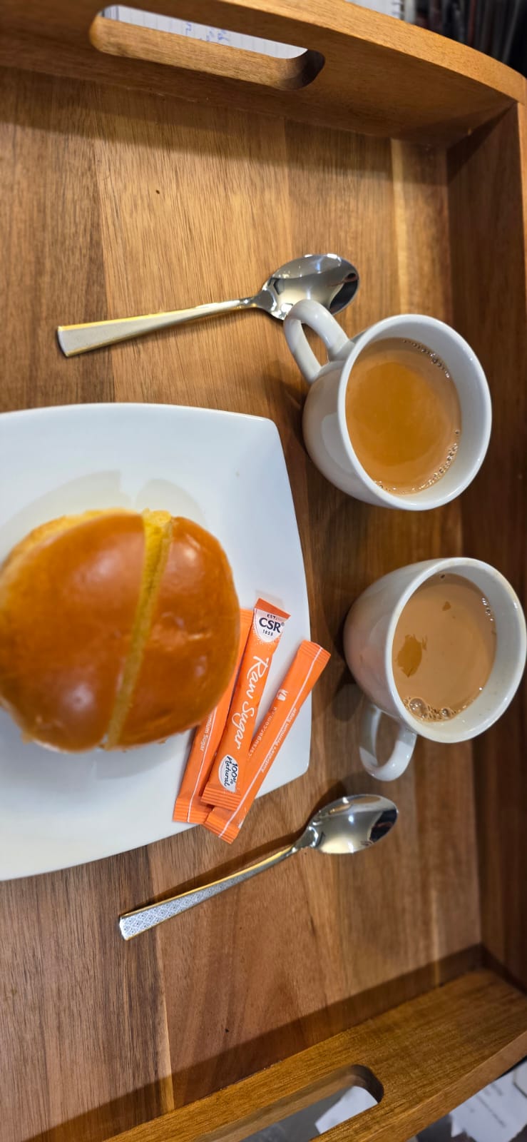 Fresh bun served with two cups of signature Kadak Chai on wooden tray at Tandoor and Chai Bedford Perth