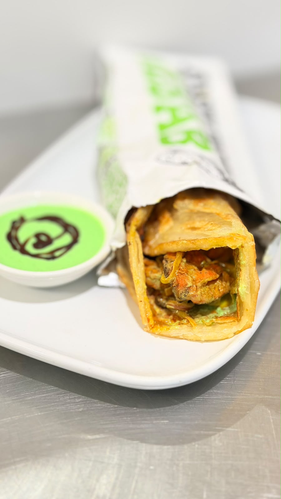 Close-up of fresh Paratha Wrap with signature creamy sauce at Tandoor and Chai Bedford Perth